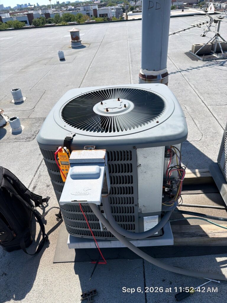 Diagnostic tools connected to an outdoor air conditioner during a GSHA Services visit in Chicago