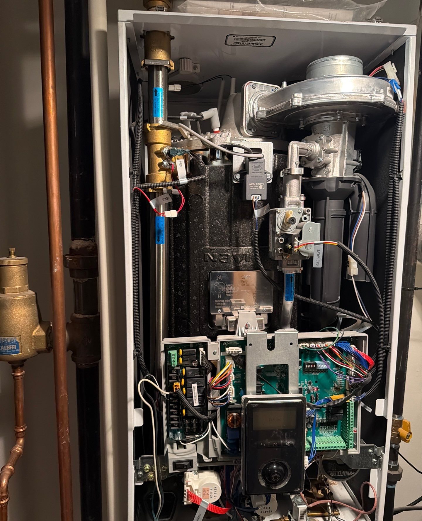 Navien condensing boiler with the cover removed during a GSHA Services repair visit